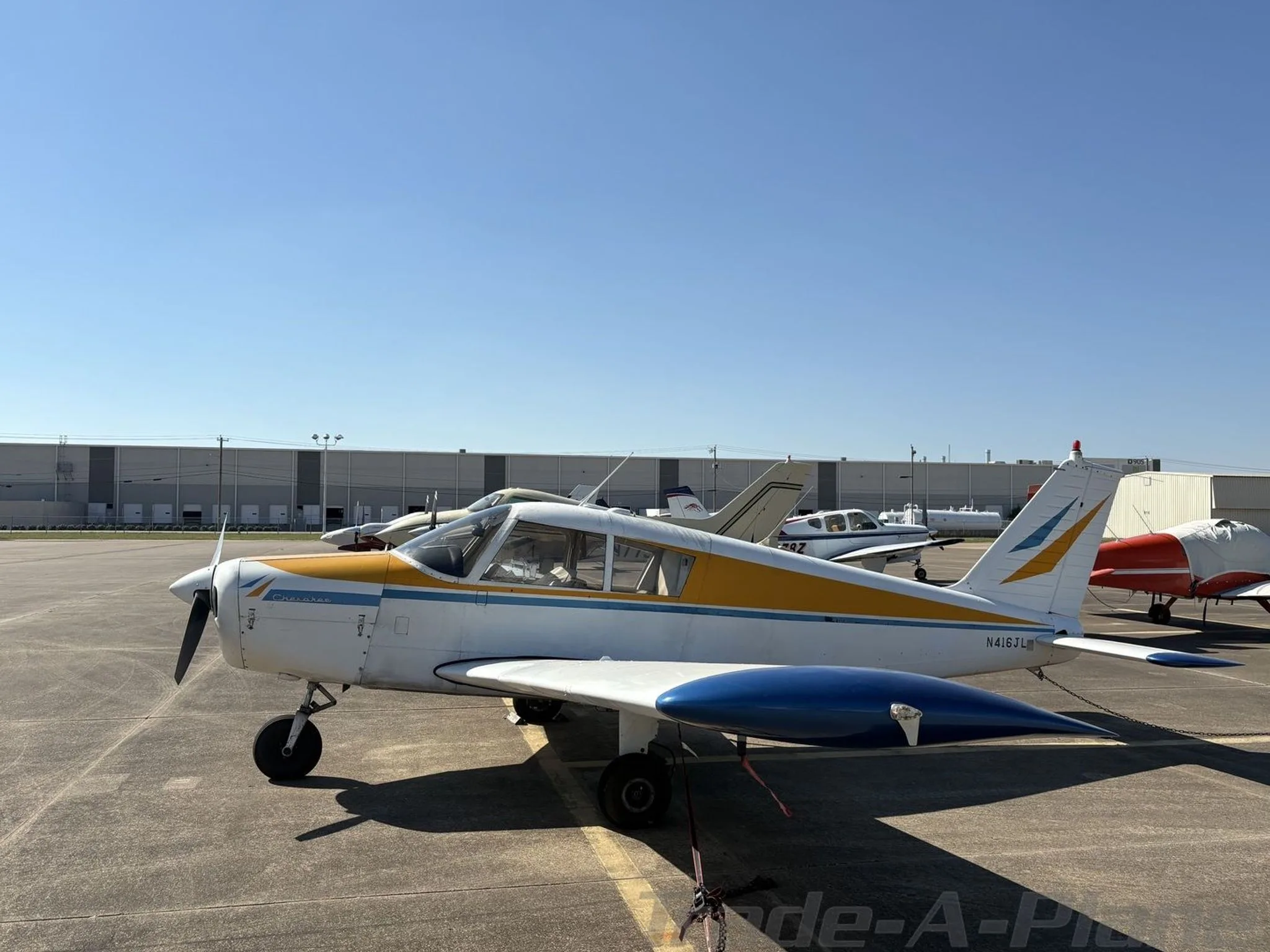 A side view of the aircraft on the tarmac.