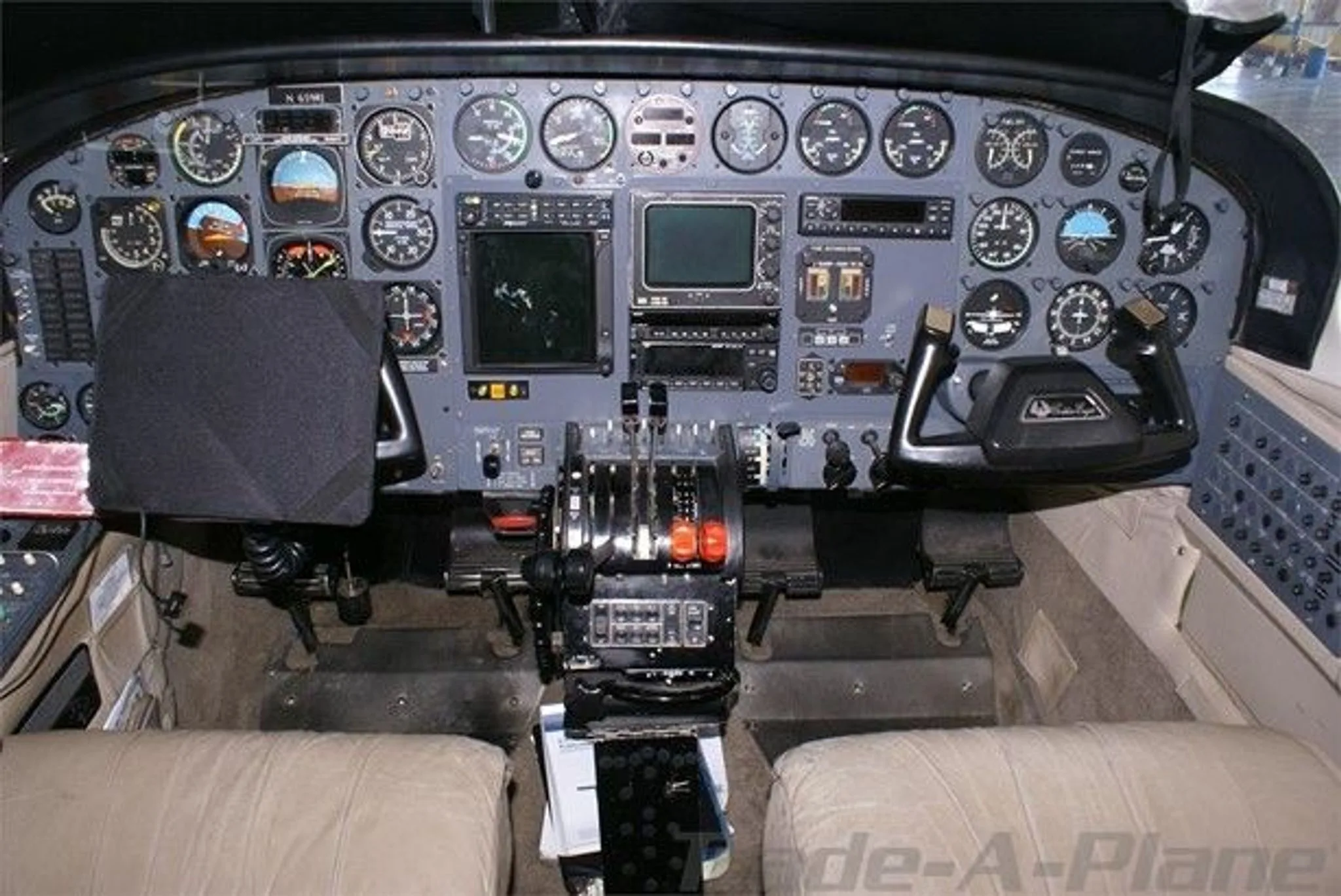 The cockpit of a Cessna 421C Golden Eagle, showing the instrument panel, yokes, and throttle quadrant.