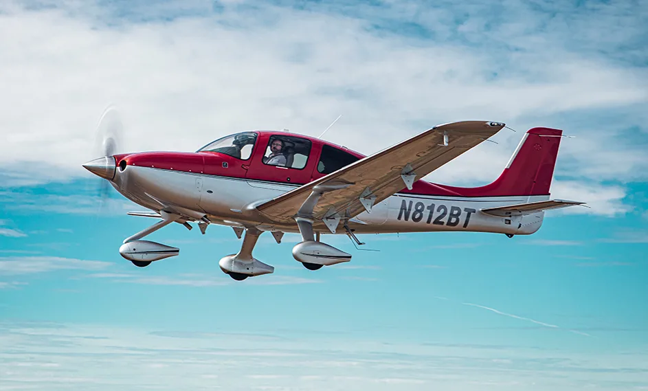 Cirrus SR22 aircraft N812BT in flight with a red and silver paint scheme.