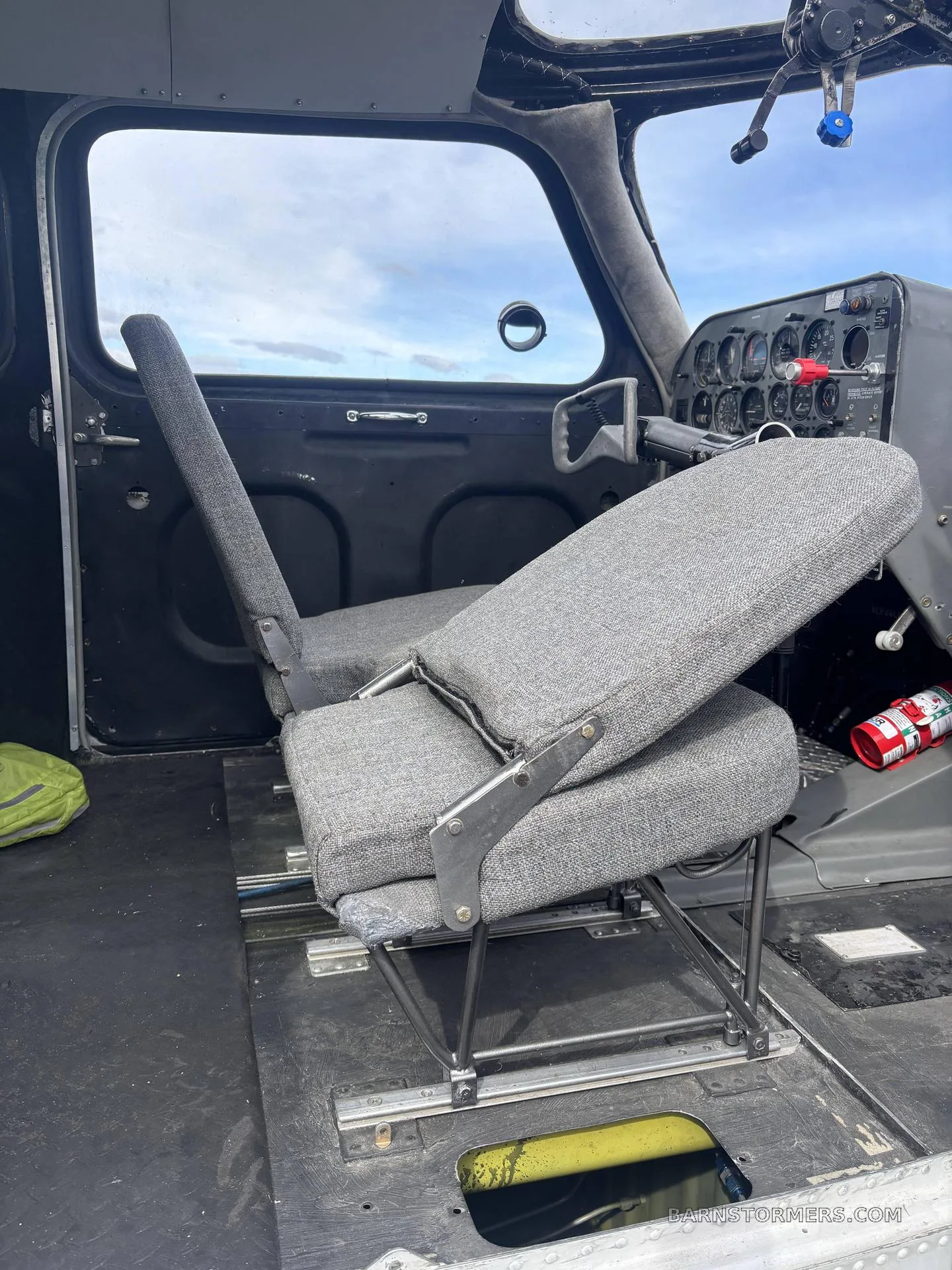 The two gray fabric front seats of a Republic RC-3 Seabee, with the instrument panel visible in the background.