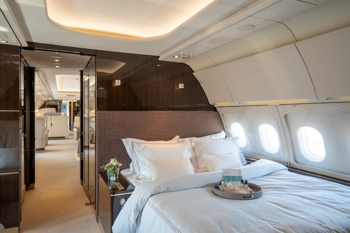 Aircraft interior featuring a bedroom with a large bed.