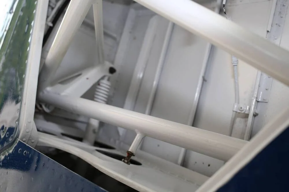 A close-up view of the white internal structural framework and components of an aircraft.