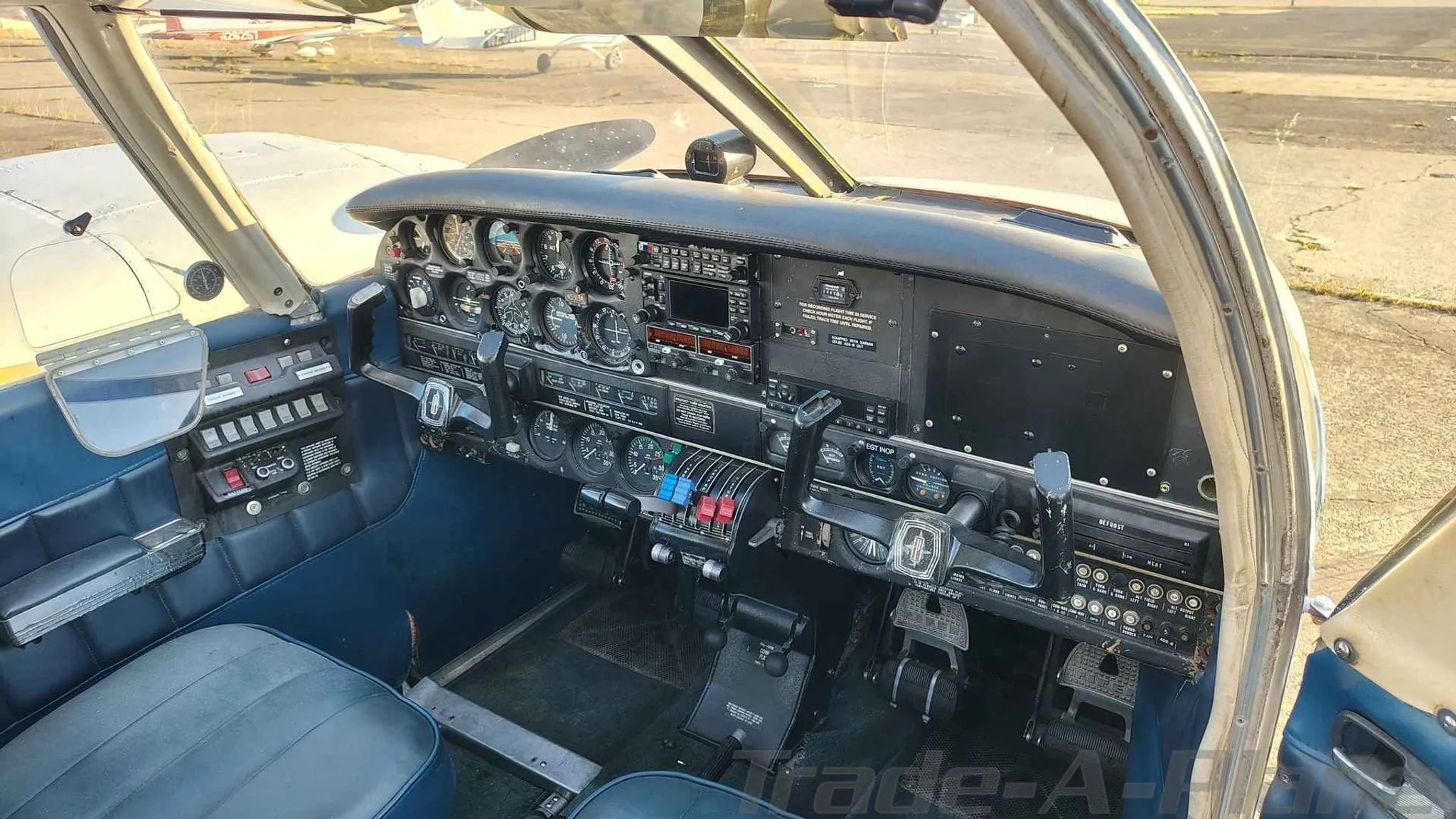 A detailed view of the cockpit instrument panel and controls of a Piper PA-23-200.