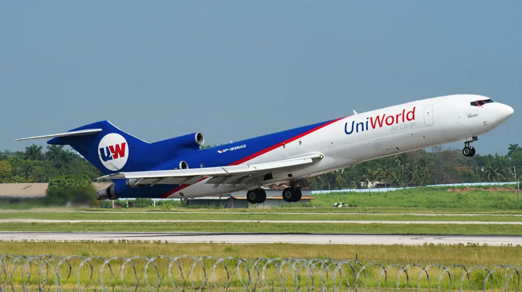 A UniWorld Air Cargo Boeing 727-200F, registration HP-1939UCG, takes off from a runway.