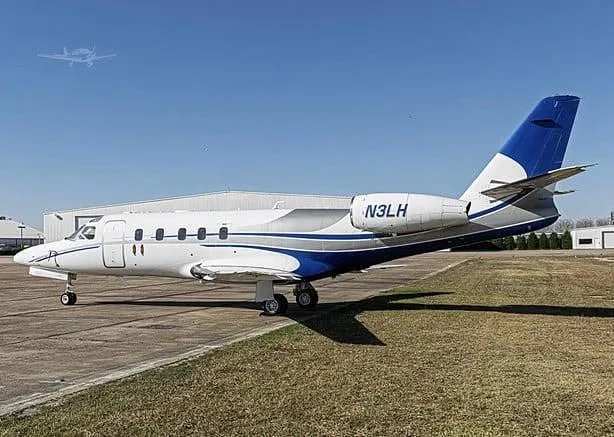 A white and blue IAI Astra business jet, tail number N3LH, parked on a tarmac with hangars in the background.