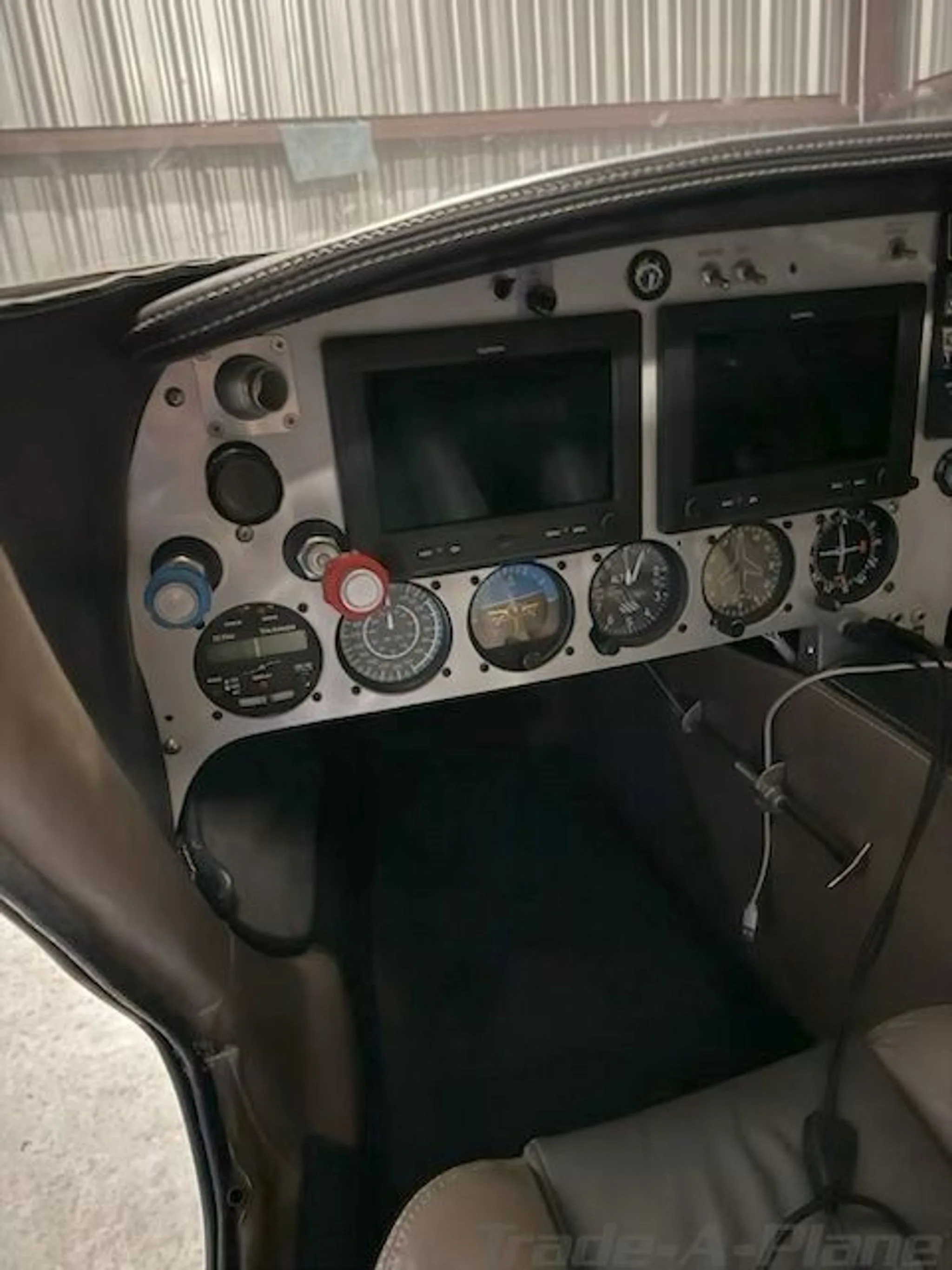 Close-up view of the aircraft's instrument panel featuring two Garmin displays and analog gauges.