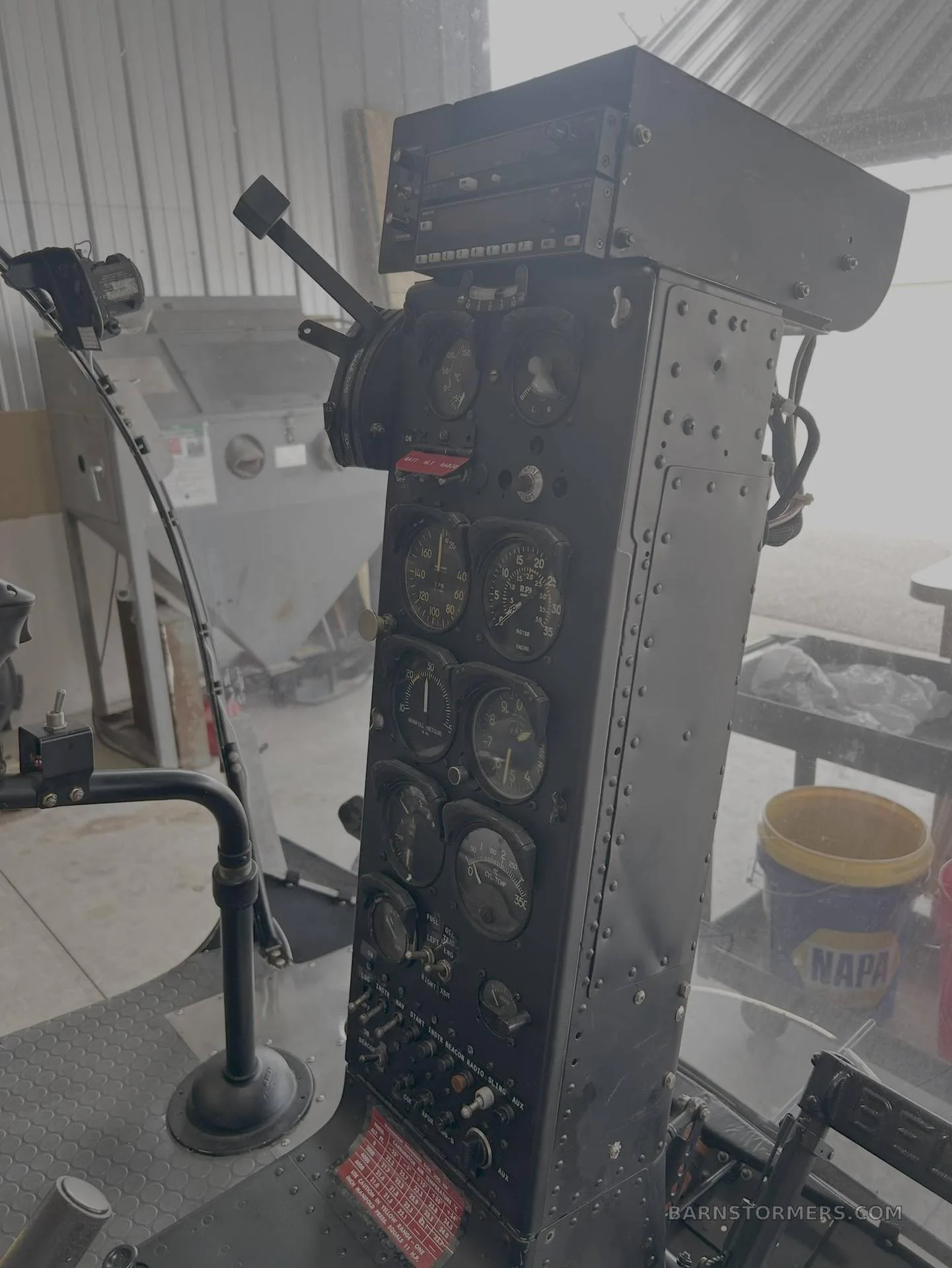 The instrument panel of a Bell 47 helicopter, featuring various gauges and controls.