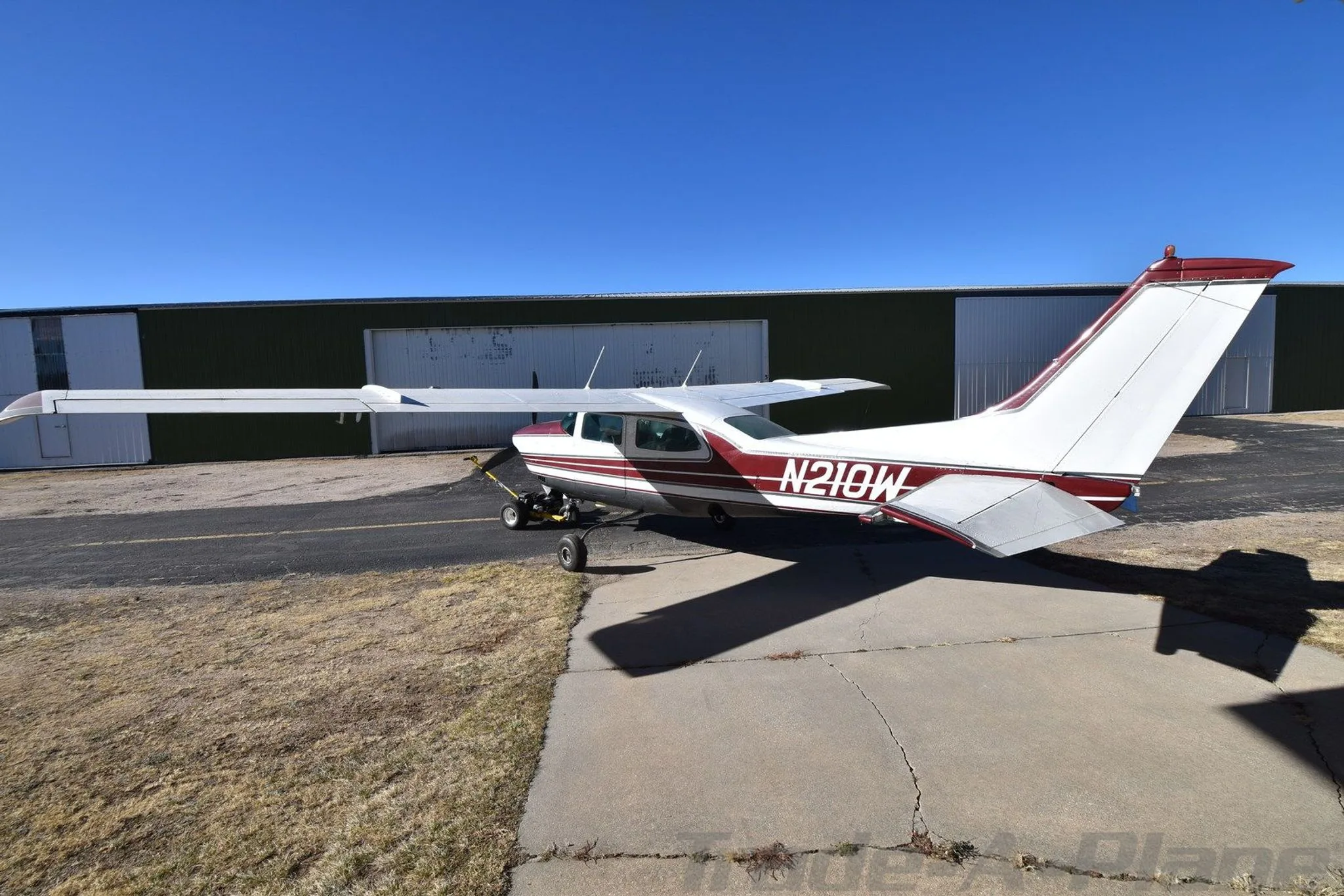 Rear view of the Cessna 210K on the ground.