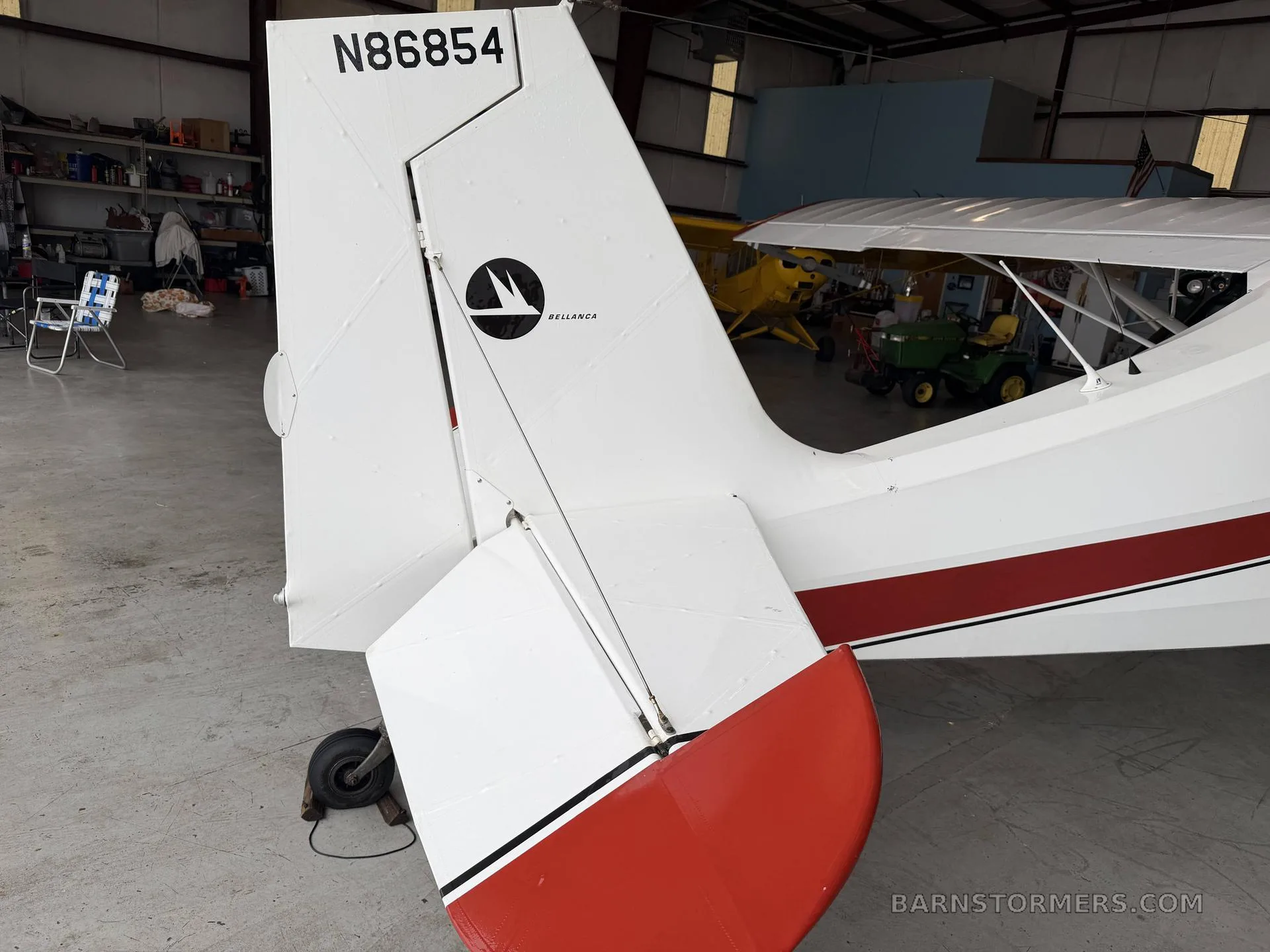 A close-up of the white tail of a high-wing aircraft, showing the N-number N86854 and a "Bellanca" logo.