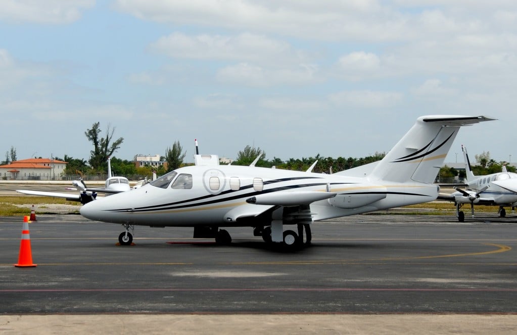 A jet with a white and black paint scheme parked on the tarmac.