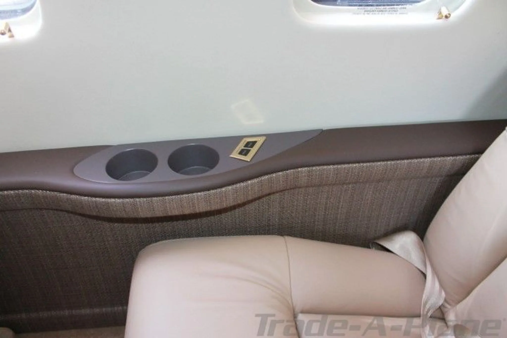 Cup holders and side panel of the cabin.